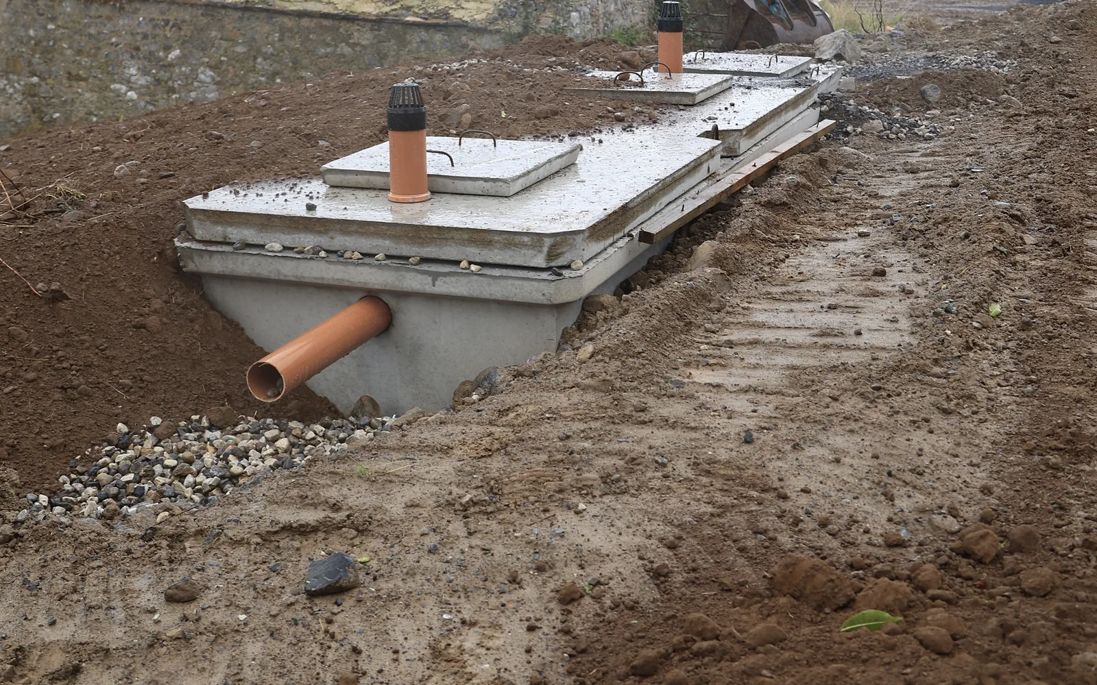 Wastewater tank and drainage pipework installed beside a new house by Carlow groundworks team